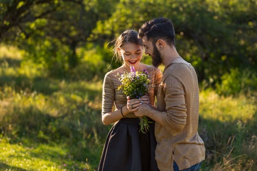 guy gives his girlfriend wild flowers