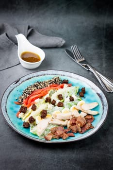 different types of meat, sesame seeds, greens and croutons