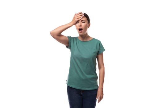 a young woman with black hair and a slim figure dressed in a green T-shirt is tired and angry.