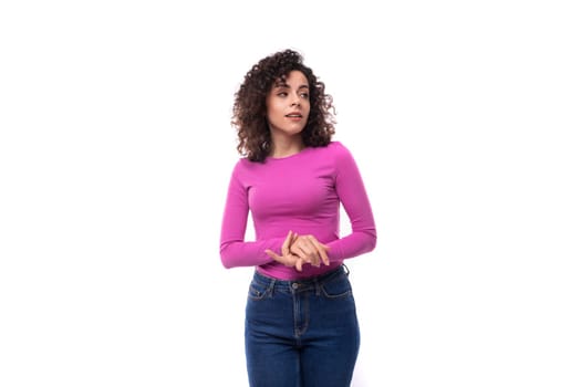 young pretty leader woman with curly black hair is dressed in a lilac jacket on a white background.