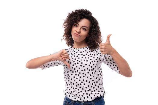 a young woman with a curly hairstyle is dressed in a summer polka dot print blouse showing like and dislike.