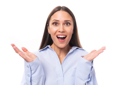 close-up portrait of surprised young brunette european woman dressed in sky blue color shirt over isolated background with copy space.