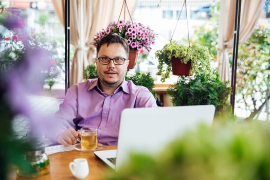 A man working on a laptop in a restaurant