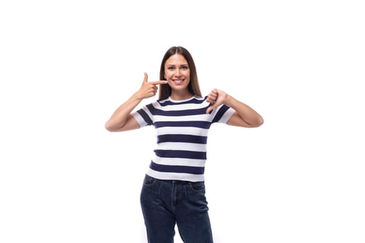 pretty slim young brunette woman in a striped t-shirt on a white background with copy space.