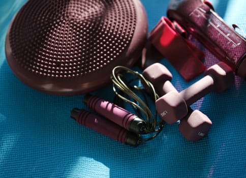 Sports accessories for home fitness dumbbells and skipping rope. Daily workout concept