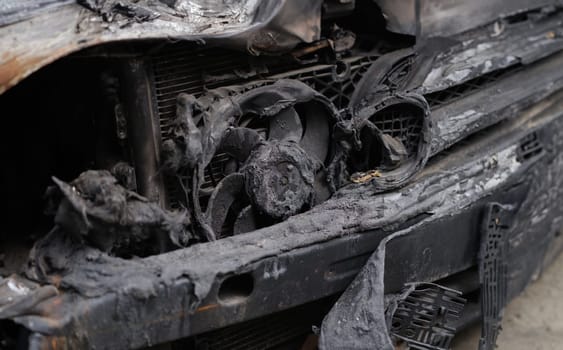 Burnt car after accident or short circuit of car wiring. Insurance compensation after car arson concept