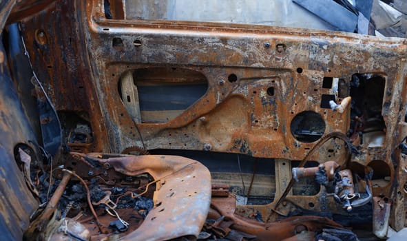 Burnt car after accident. Transport insurance. Old abandoned rusty car concept