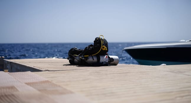 Diving equipment lying on wooden bridge in sea. Extreme sports concept