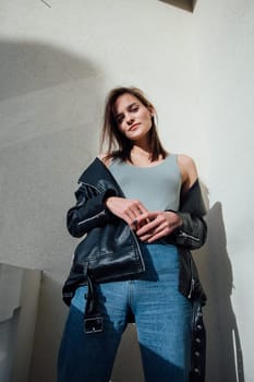 Woman in jeans posing on balcony room