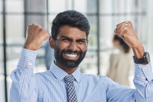 a man holding his hand up a gesture of triumph and victory.