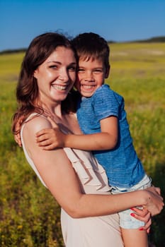 Mother and son walking in the nature of a field