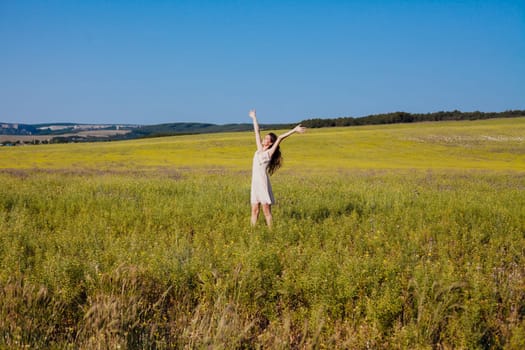 Portrait of a beautiful girl in a rural field