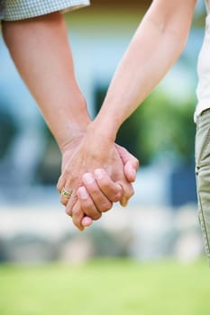 Couple, love or holding hands for support in park, nature or outdoors on a romantic walk in summer. Wellness, romance or closeup of man with woman bonding, affection or enjoying date together outside.