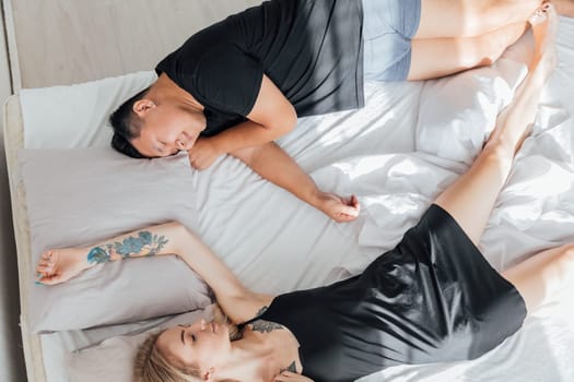 Husband and wife sleeping together in bed