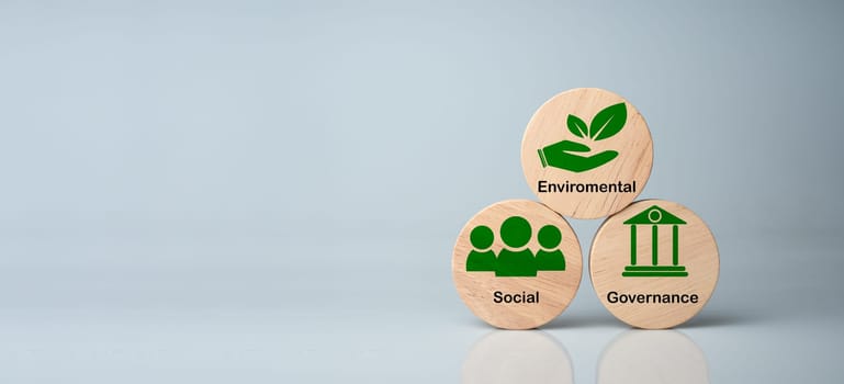 ESG concepts for sustainable environment, society and governance Businesses are environmentally responsible. A  wooden circular board with the abbreviation ESG printed on a white background.