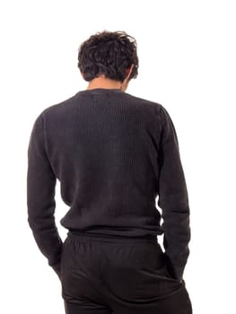 A man in a black sweater and black pants, seen from the back, unrecognizable, looking at something, isolated on white