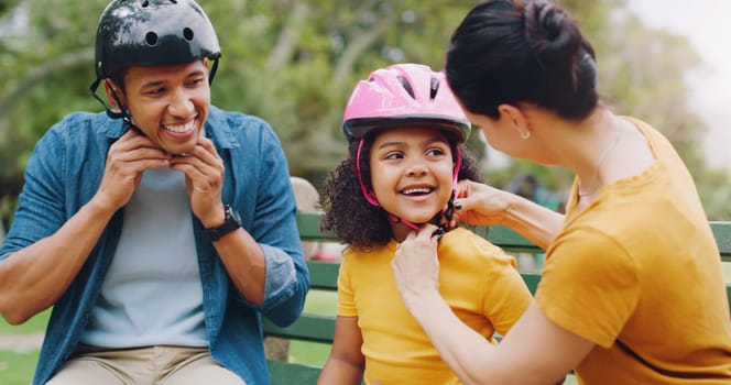 Parents, park bench and helmet with child, help and safety for skating, rollerskate or bike. Interracial parents, mom and dad with helping hand, teaching and kid for bonding, learning and exercise.