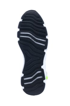 Black rubber sole of the sneaker with white inserts isolated.