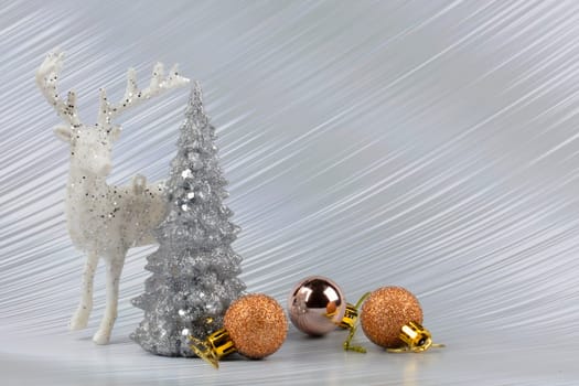 Christmas or New Year background with silver snowy tree and golden transitional decoration, deer. Bright festive background.