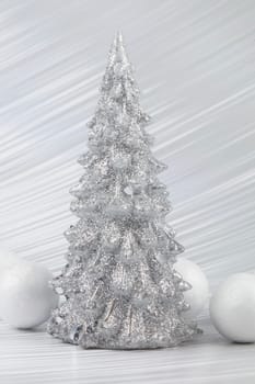 Christmas or New Year background with silver snowy tree and white transitional decoration. Bright festive background.