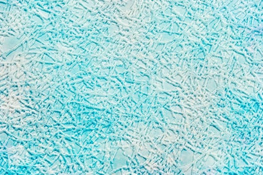 On a pale blue paper background, textured strokes imitating hoarfrost or a pattern of hoarfrost on glass.