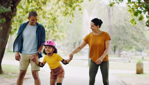 Parents, park and holding hands to rollerskate with girl child with care, learning and support. Interracial family, black man and woman with kid, smile and helping hand for skating on outdoor holiday.