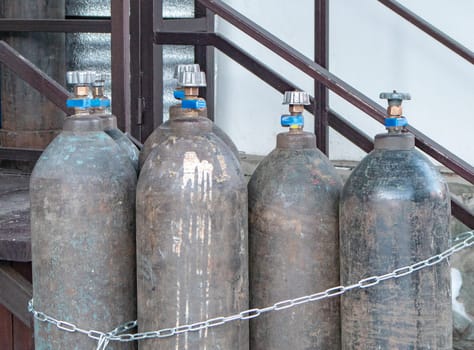 Close-up of steel cylinders with compressed gas - argon, carbon dioxide or oxygen for welding, outdoors.