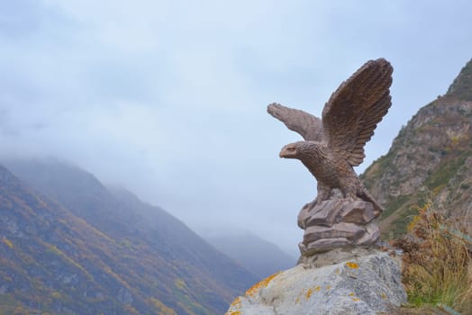 Eagle statue in the Caucasus mountains, Stavropol region, Russia. Monument on top of a mountain against the sky on a foggy autumn day