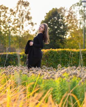 Beautiful girl posing in the sunshine in an autumn park