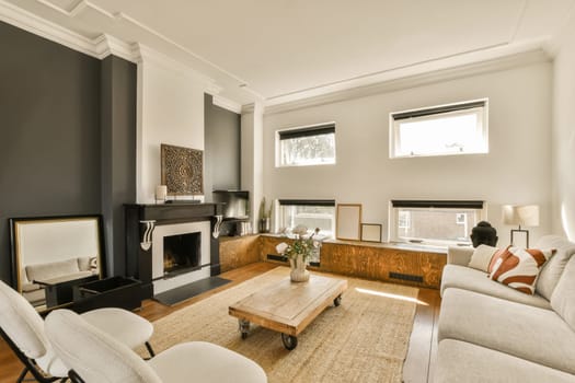 a living room with two couches and a coffee table in front of the fire place on the right side