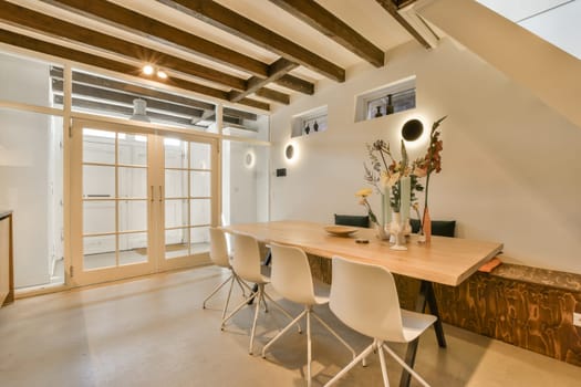 a home office with white chairs and a wooden table in the center of the room is an open space for work