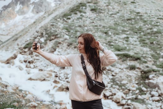 A woman taking selfie in the mountains