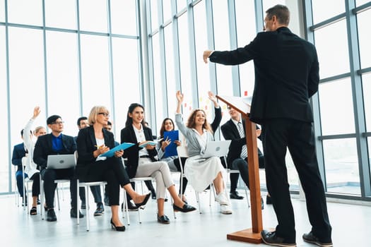 Group of business people meeting in a seminar conference . Audience listening to instructor in employee education training session . Office worker community summit forum with expert speaker . Jivy