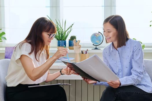 Middle-aged female professional psychologist and young woman talking, therapy meeting. Social worker, therapist, counselor working with 20s patient. Support, mental health, psychology, psychotherapy