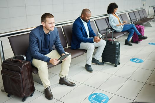 Traveling, tablet and man in airport, passport and luggage with tourist waiting, boarding or international. Male leader traveler or gentleman with suitcase, departure and ticket for travel and online.