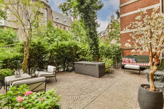 an outdoor living area with furniture and trees in the fore - image is taken from google's street view