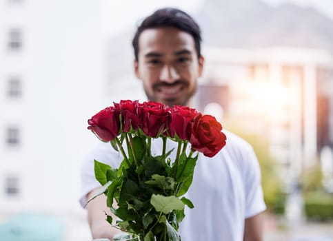 Love, gift and portrait of happy man with roses for date, romance and valentines day. Smile, romantic hope and person giving bouquet of flowers in city, proposal or engagement on blurred background