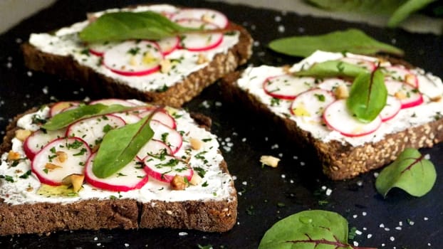 Delicious sandwiches with soft cream cheese and radish. Vegetarian food.