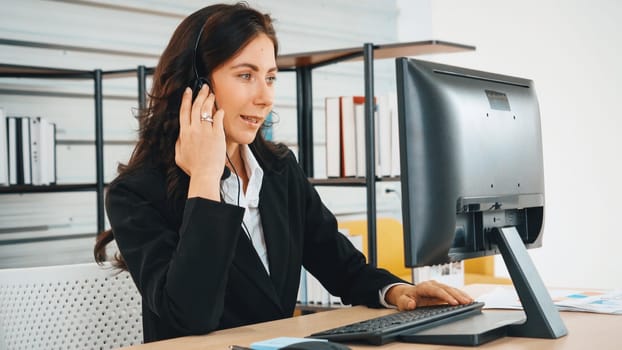 Business people wearing headset working in office to support remote customer or colleague. Call center, telemarketing, customer support agent provide service on telephone video conference call. Jivy