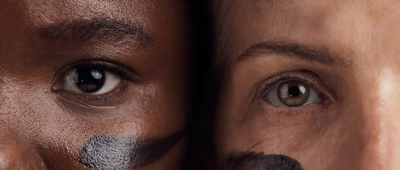 Eyes, diversity and empowerment with women closeup in studio for human rights or gender equality. Portrait, face and courage with confident female people in a politics protest of violence together.