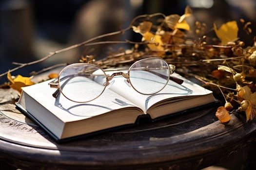 Glasses on an open book on an autumn background.