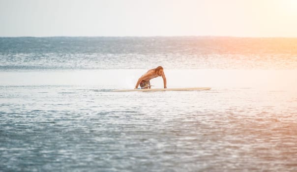 Asian man swimming in sea water and paddleboarding passing beautiful sea at summer sunset. Healthy strong male enjoy outdoor active lifestyle and water sports on holiday vacation