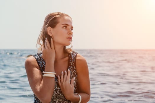 Woman travel sea. Young Happy woman in a long red dress posing on a beach near the sea on background of volcanic rocks, like in Iceland, sharing travel adventure journey