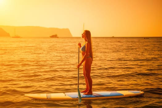 Close up shot of happy young caucasian woman looking at camera and smiling. Cute woman portrait in bikini posing on a volcanic rock high above the sea