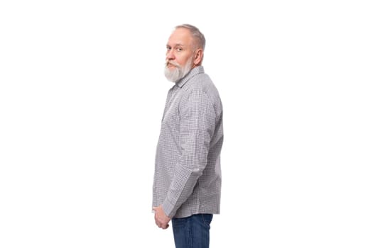 handsome gray-haired elderly man with a beard in a checkered shirt on a white background with copy space.