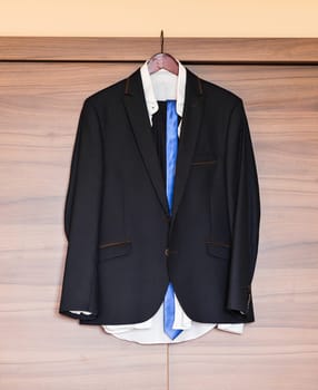 Formal suit in fashion concept. black suit and blue tie