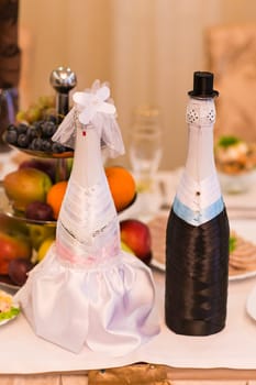 Champagne bottles decorated as a bride and groom.