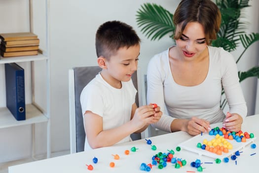 a female psychologist develops boy fine motor skills development learning