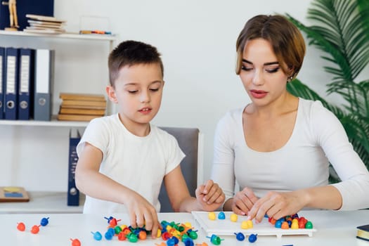 a female psychologist develops boy fine motor skills development learning