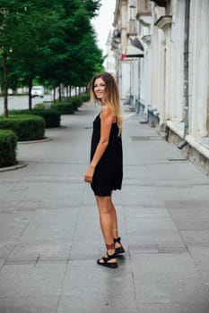 a woman in black dress on the street walk travel vacation